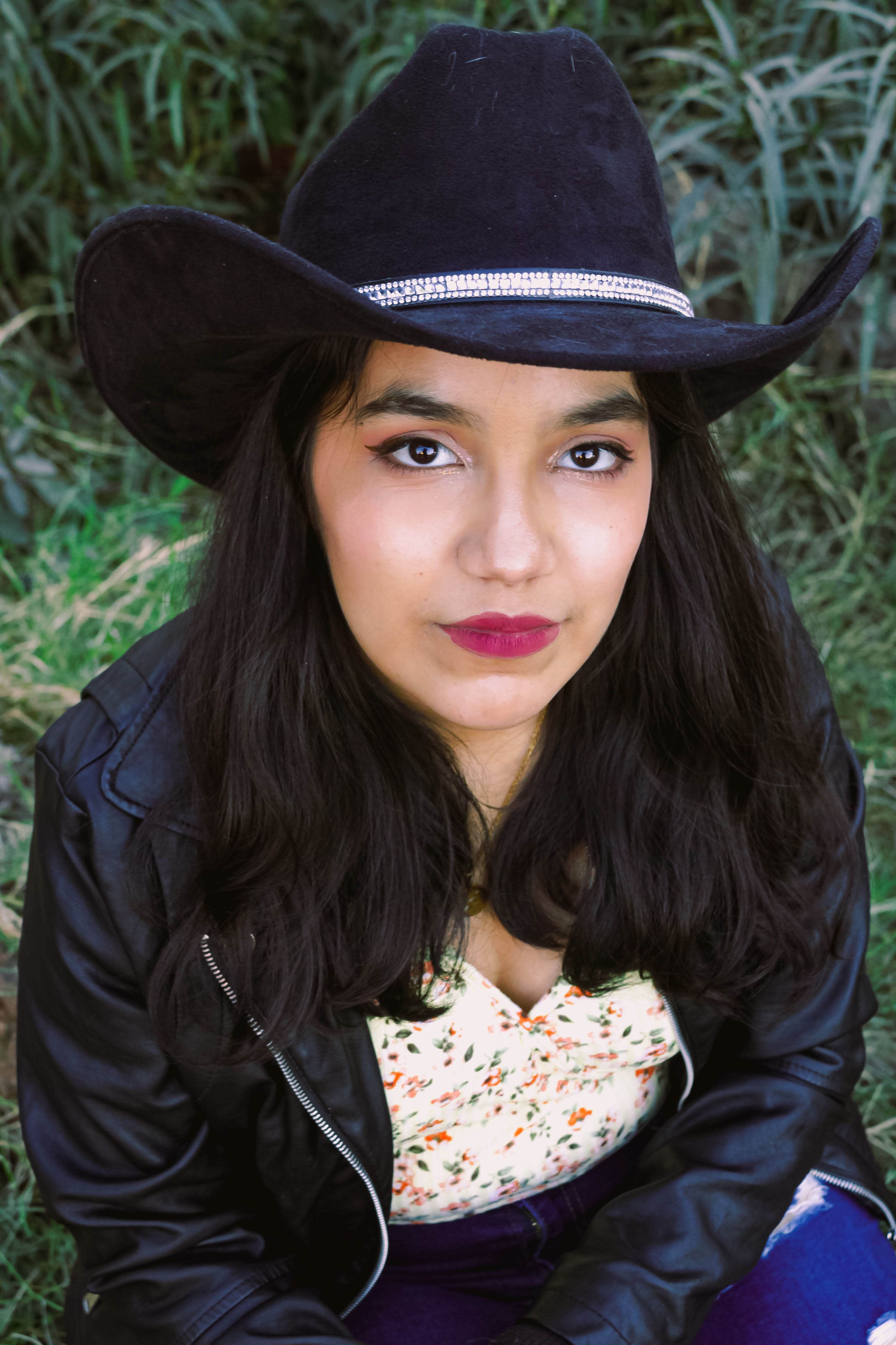 A Woman in Black Dress Wearing Cowboy Hat while Smiling at the Camera   Free Stock Photo