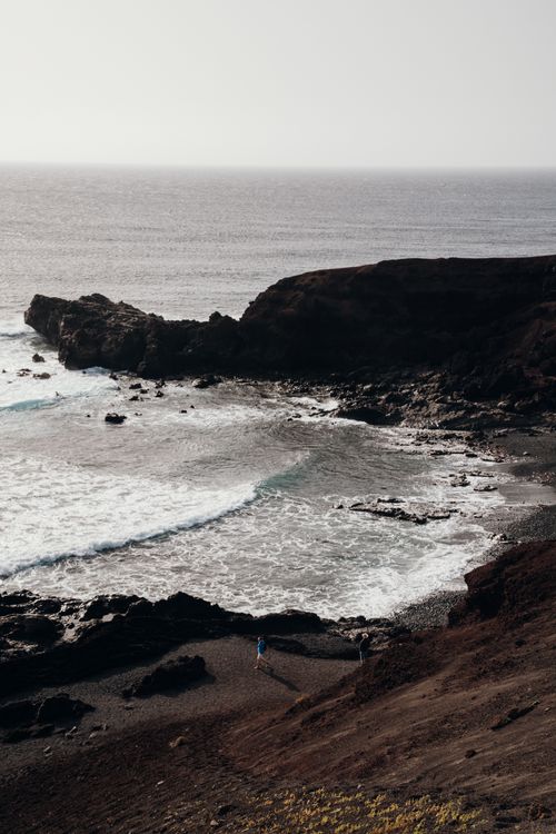 Free Breathtaking view of rocky cliffs and ocean waves on Lanzarote's coast in Spain. Stock Photo