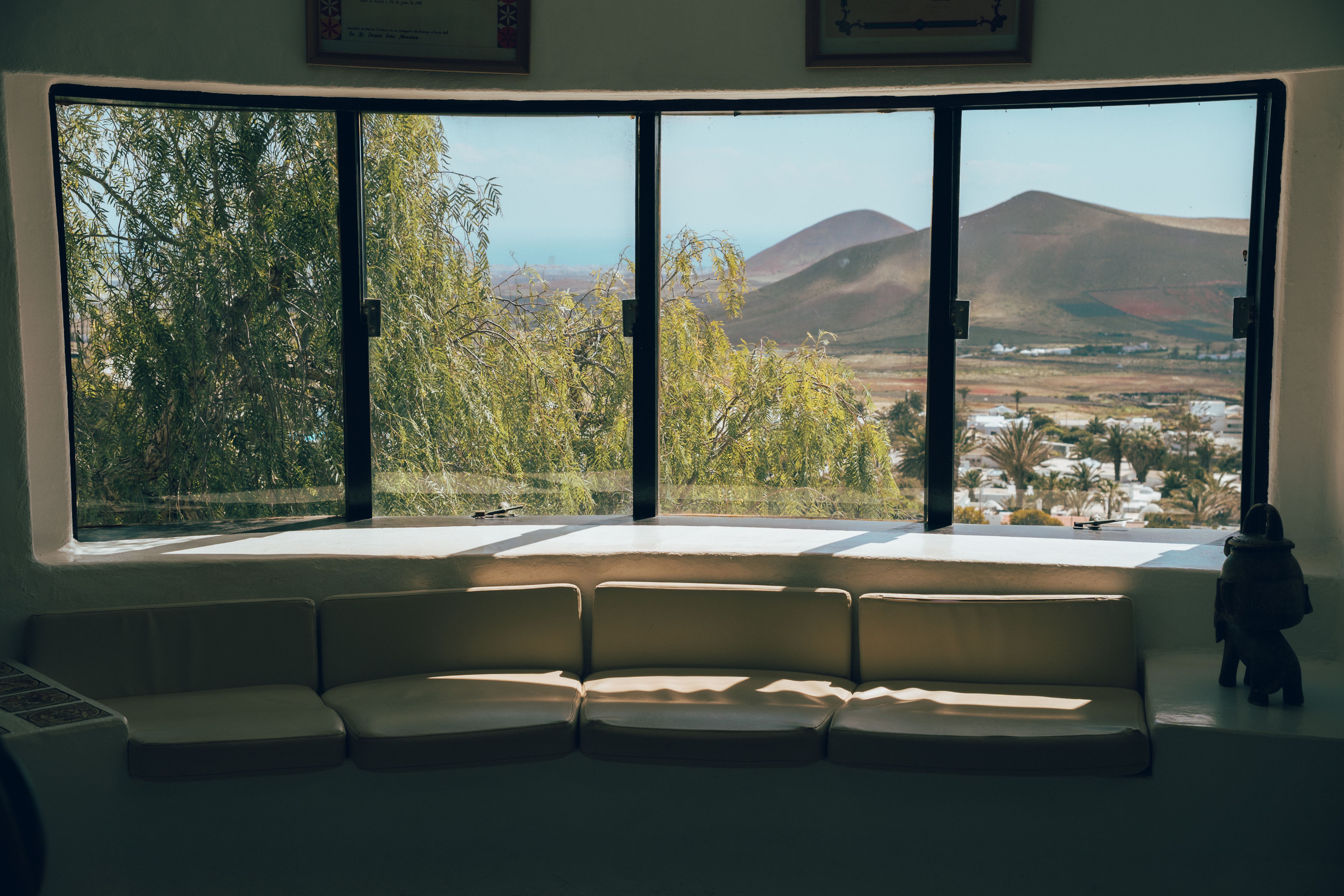 Cozy interior view showcasing Lanzarote's beautiful landscape through large windows.