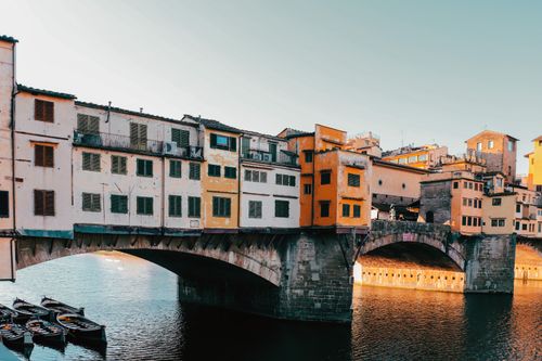 Free Captivating view of the historic Ponte Vecchio bridge in Florence during sunset. Stock Photo