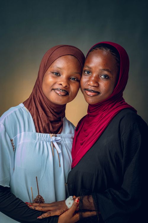 Free Warm portrait of two smiling women wearing hijabs embracing each other. Stock Photo