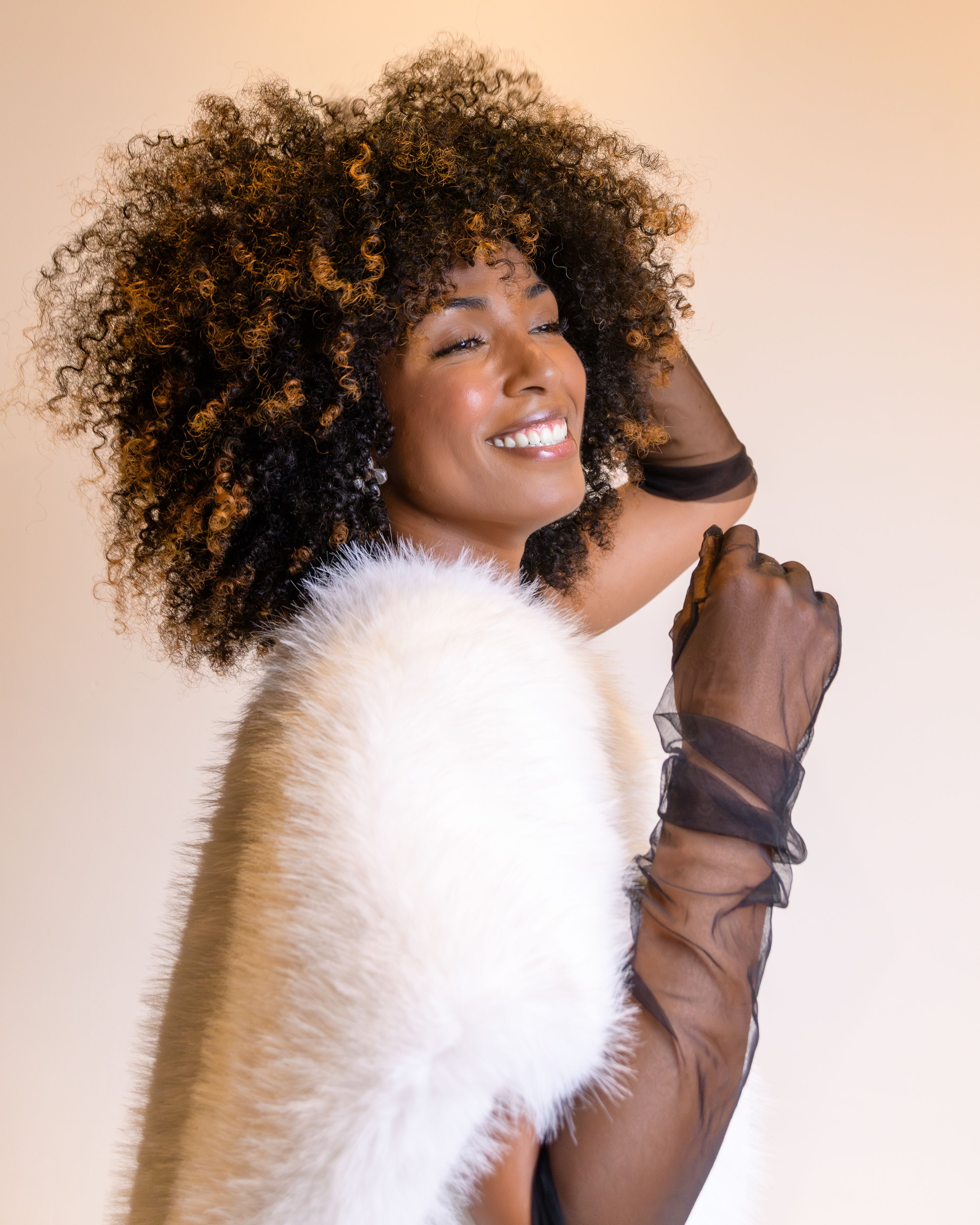 Elegant Portrait of Smiling Woman with Curly Hair · Free Stock Photo