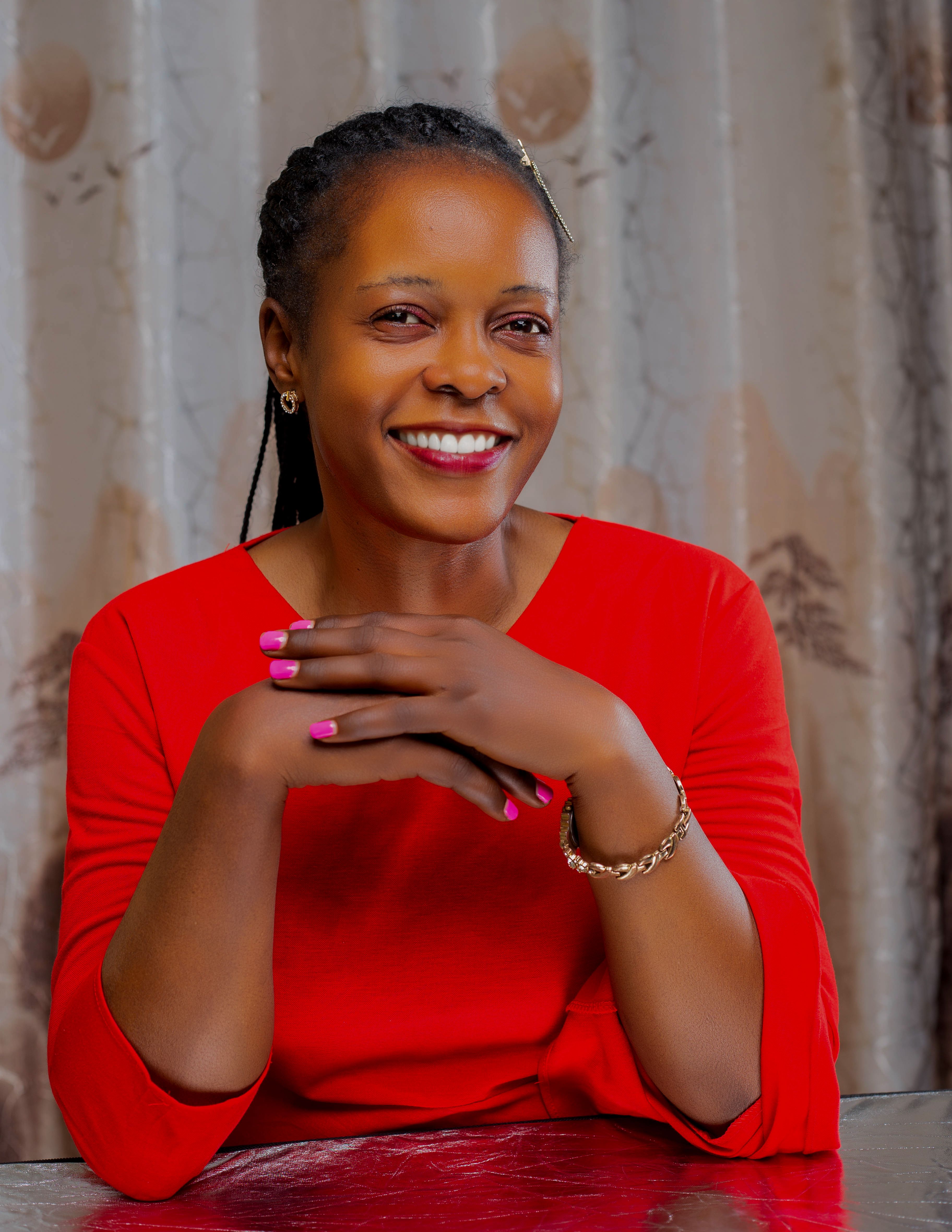 Smiling Woman in Red Dress with Braided Hair · Free Stock Photo