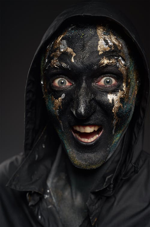 Person in Black and Golden Face Mask