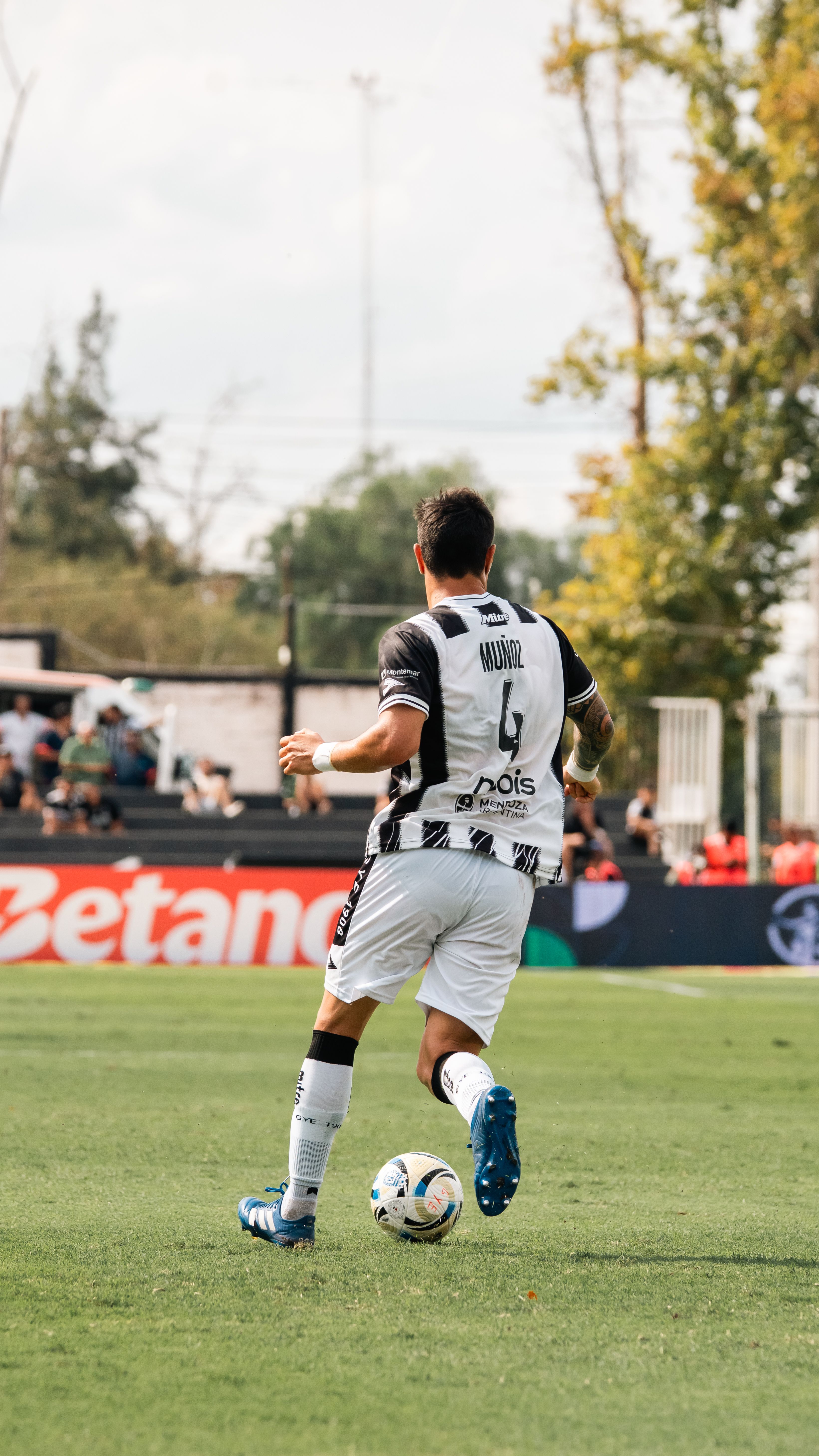 Dynamic image of a soccer player during a game, emphasizing athleticism and teamwork.