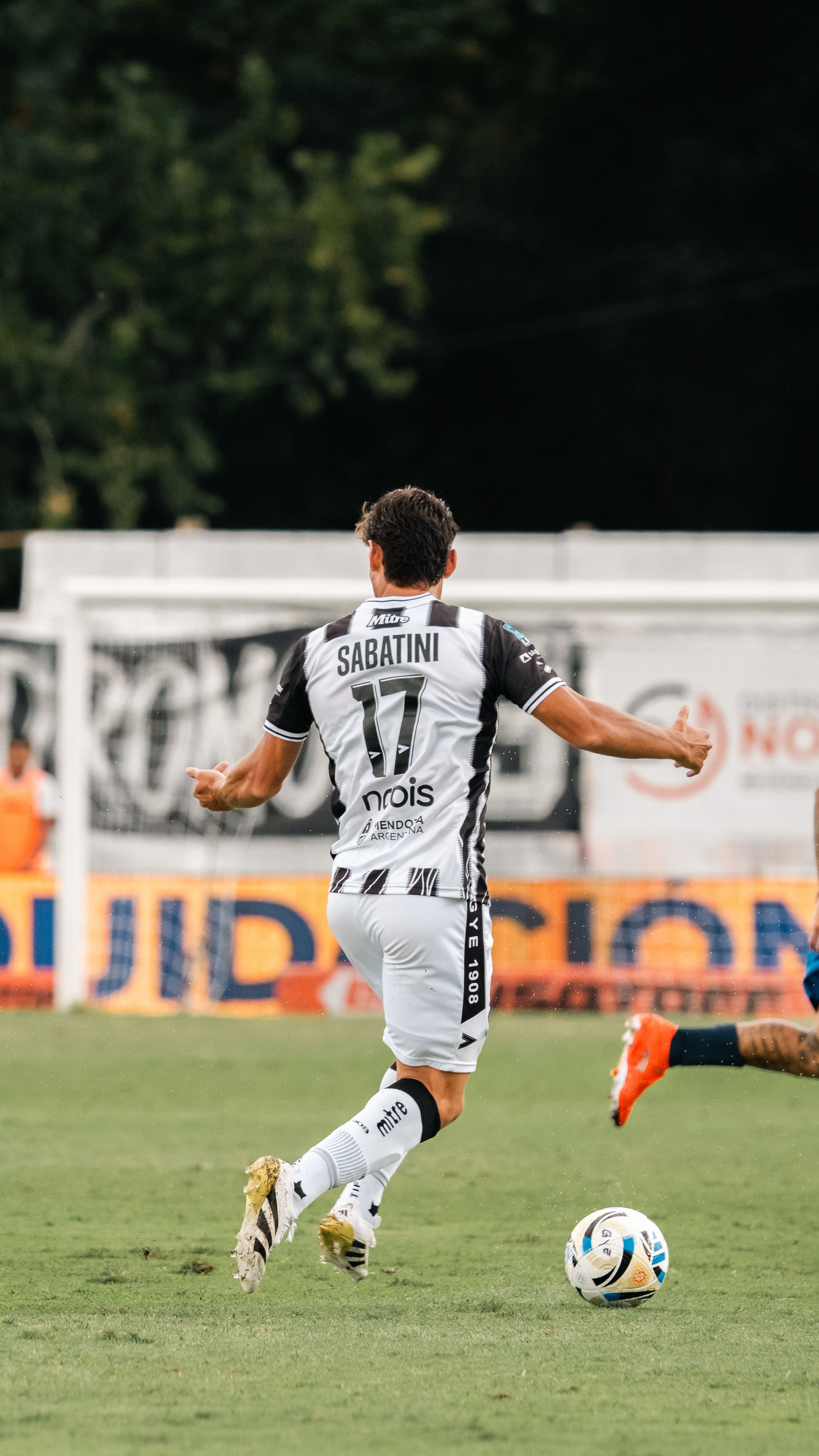 Dynamic shot of a soccer player in motion during a competitive match outdoors.