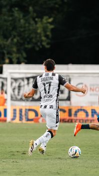 Dynamic shot of a soccer player in motion during a competitive match outdoors.