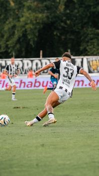 Dynamic photo of a soccer player in action on the field.