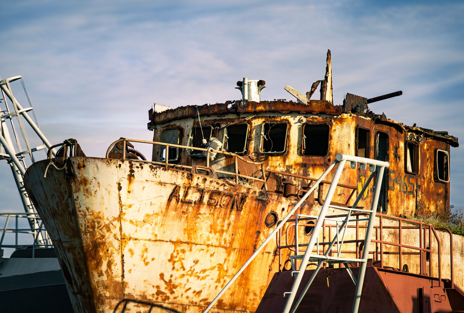 A close-up of a rusted abandoned ship named ALISON, adding a nostalgic touch to the scenery.