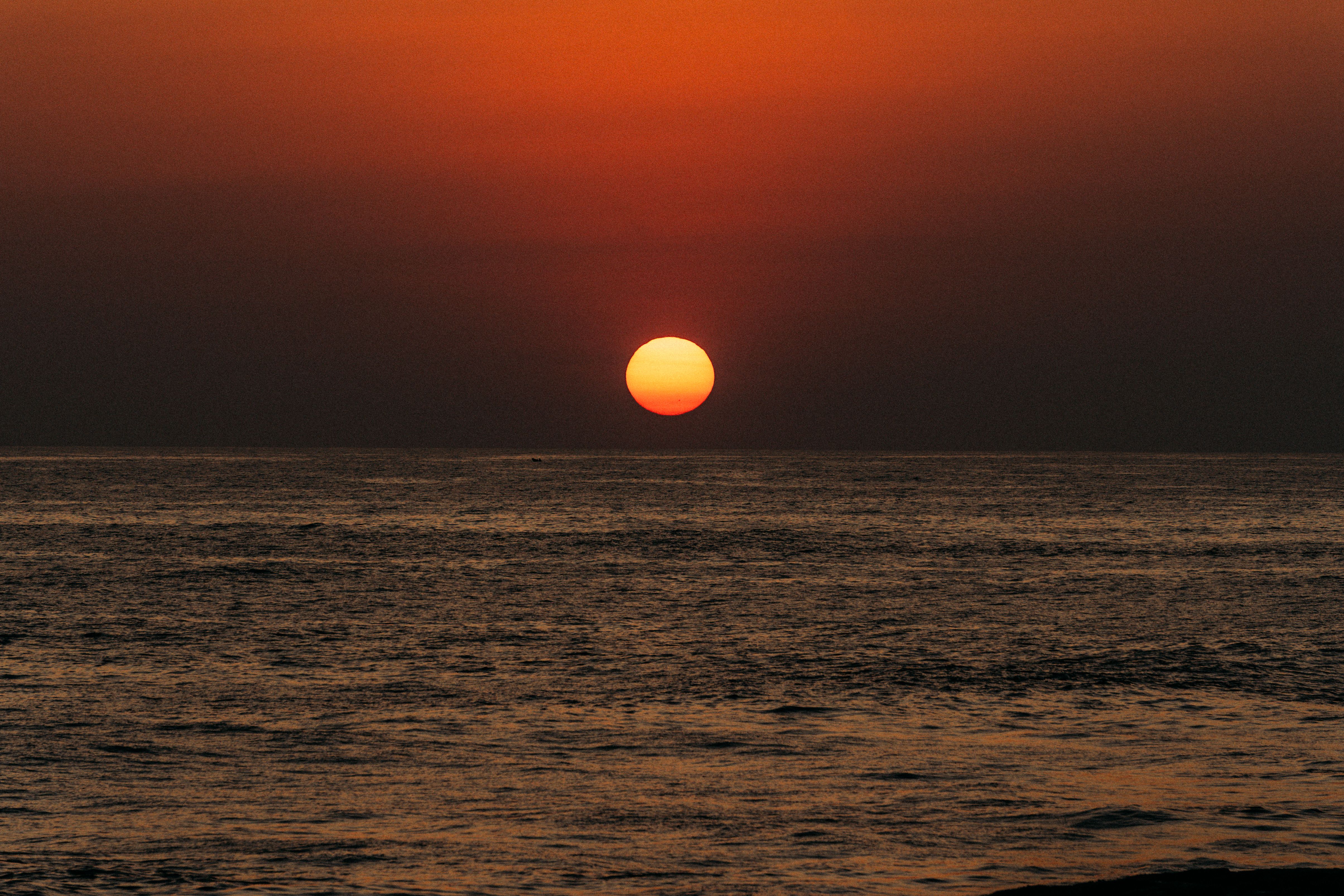 Stunning Ocean Sunset with Vibrant Orange Sky · Free Stock Photo