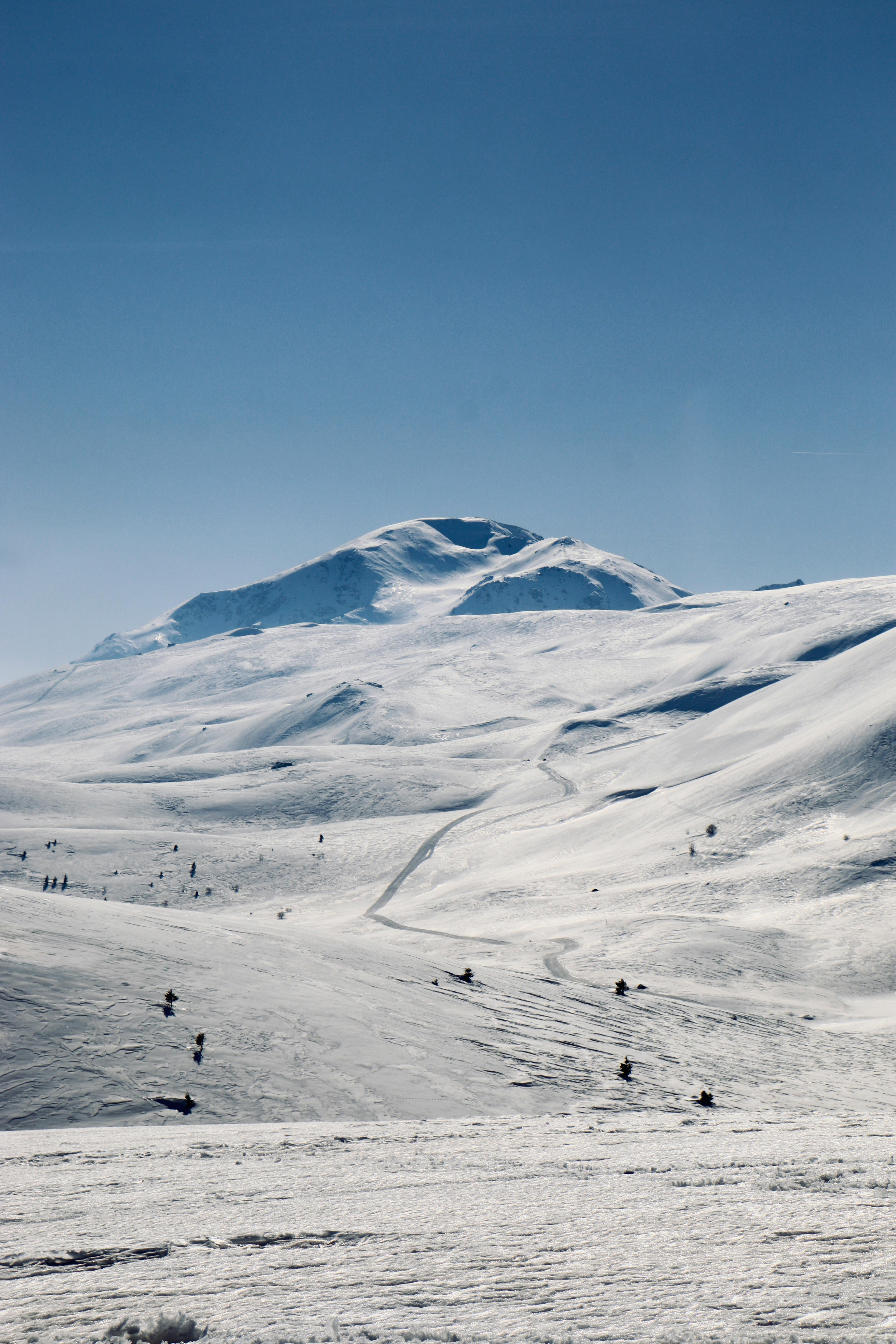 Wide view of snowy mountains at Popova Shapka, ideal for winter sports enthusiasts.