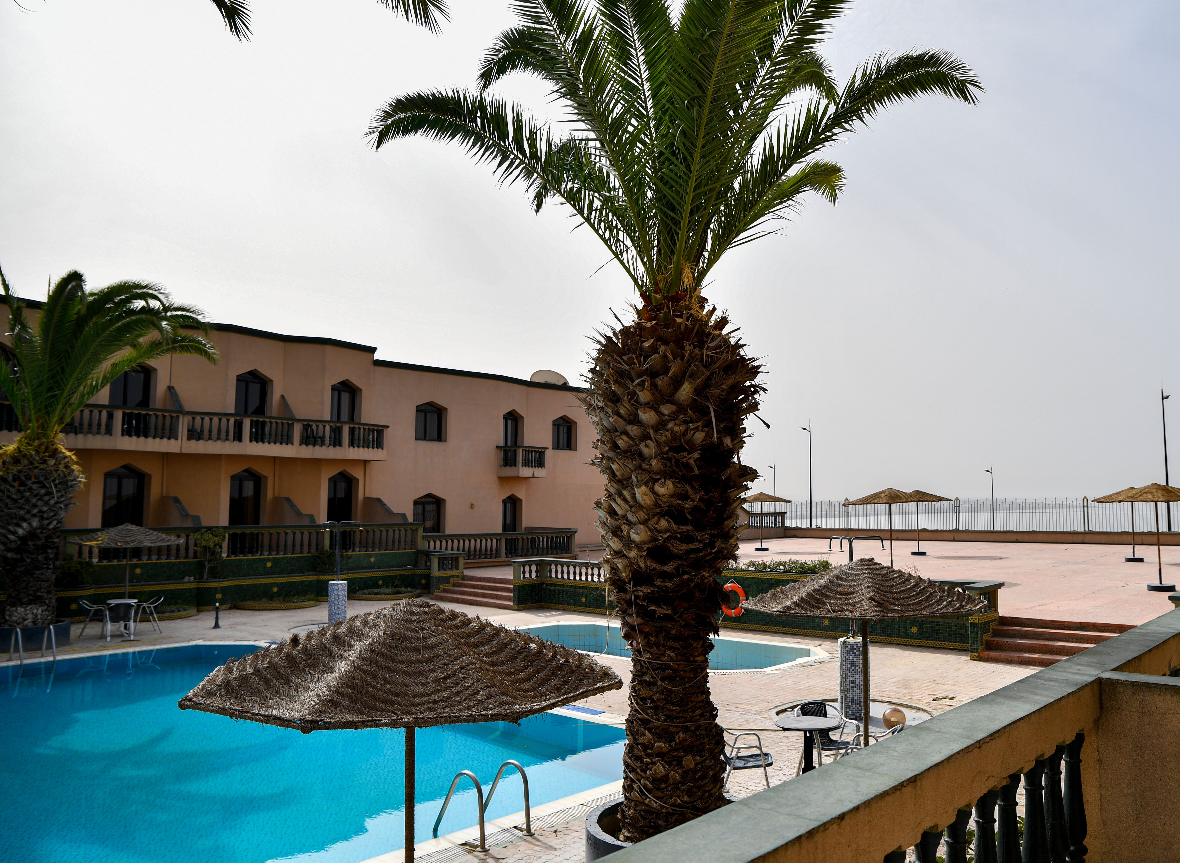 Quiet garden hotel courtyard with palms and reflecting pool in Luxor