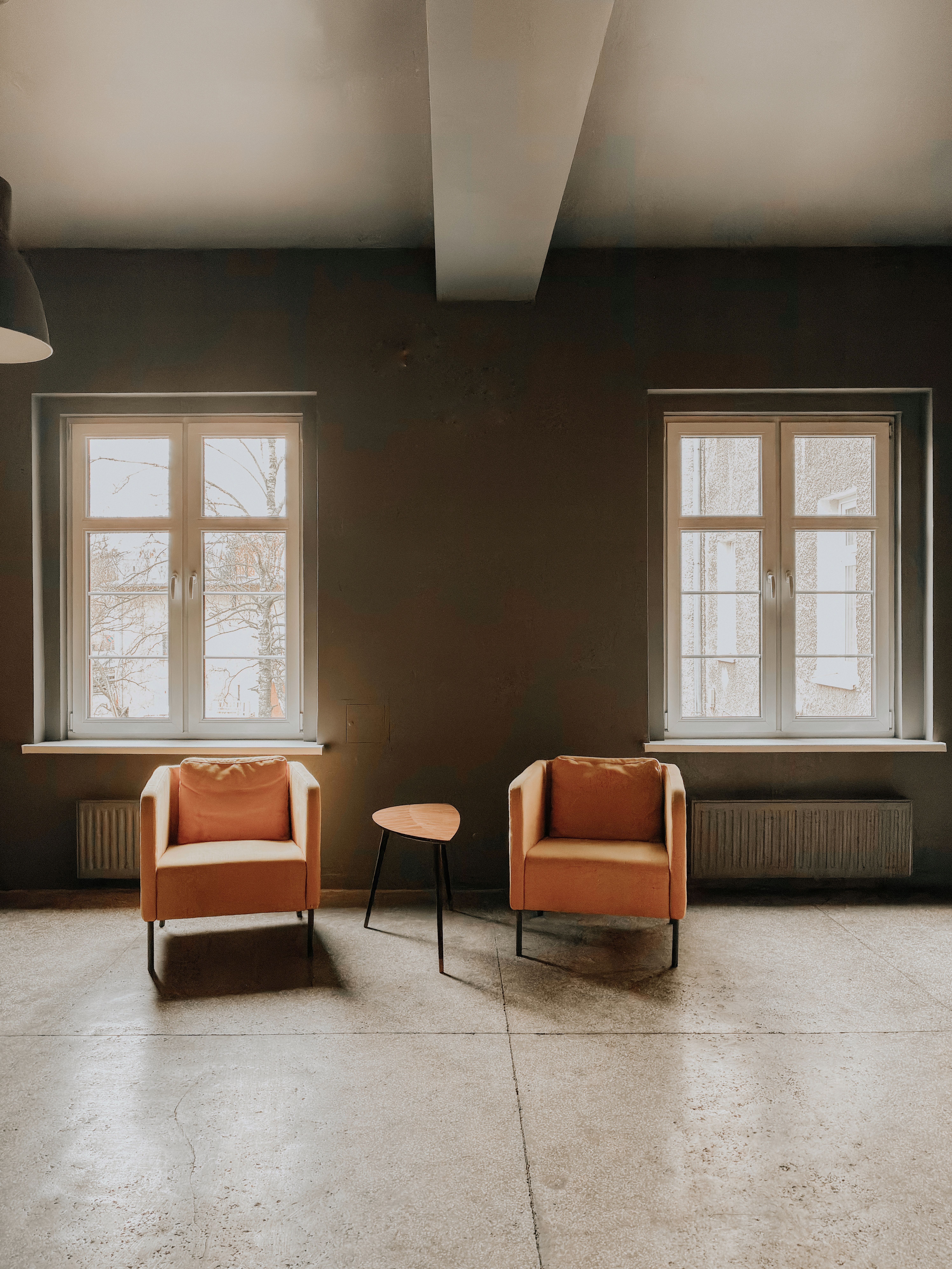 Two chairs facing one another in a quiet room filled with natural light