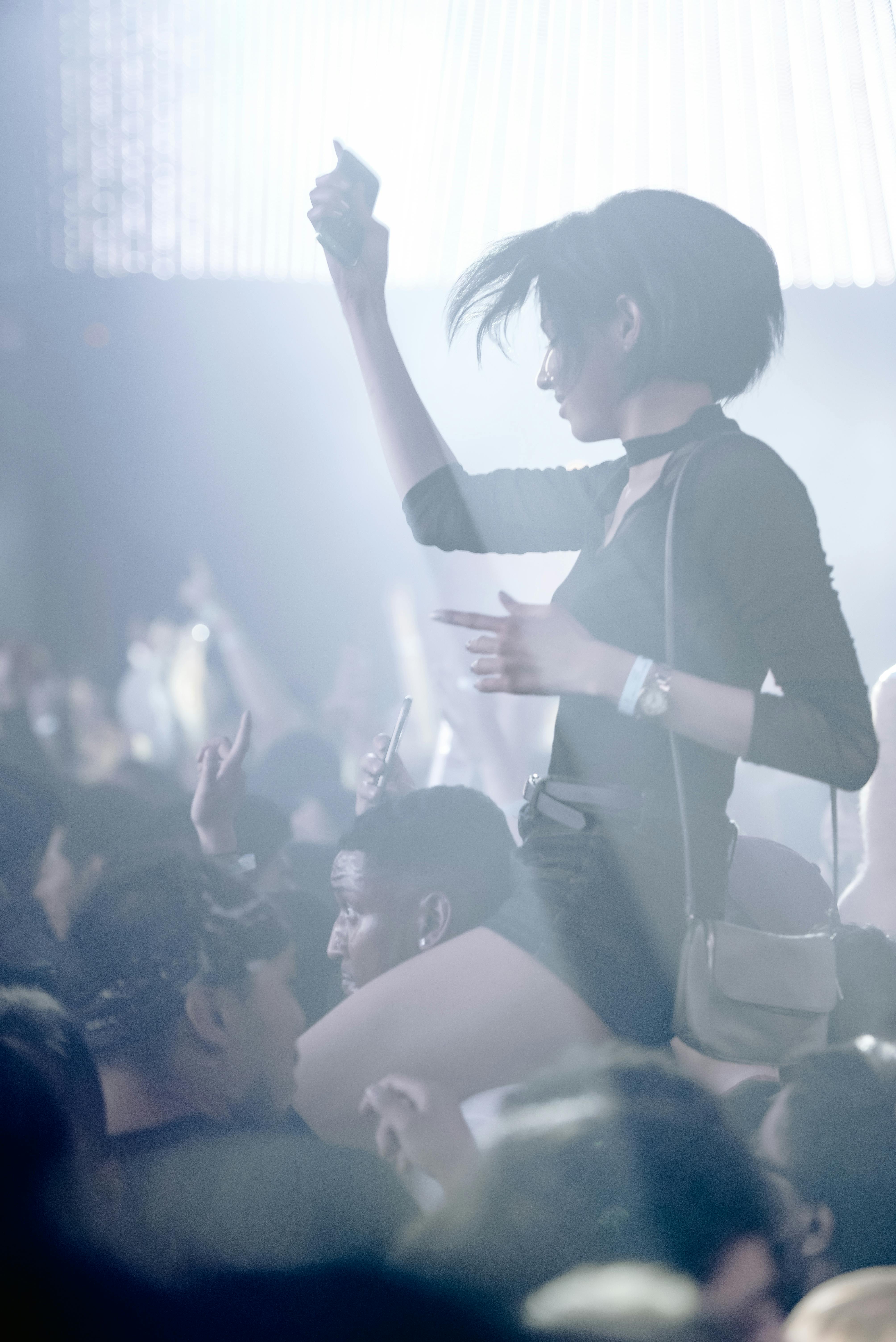 woman in black and white long sleeve shirt enjoying at a party