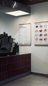 Cozy coffee shop corner showcasing a sleek espresso machine and menu boards.