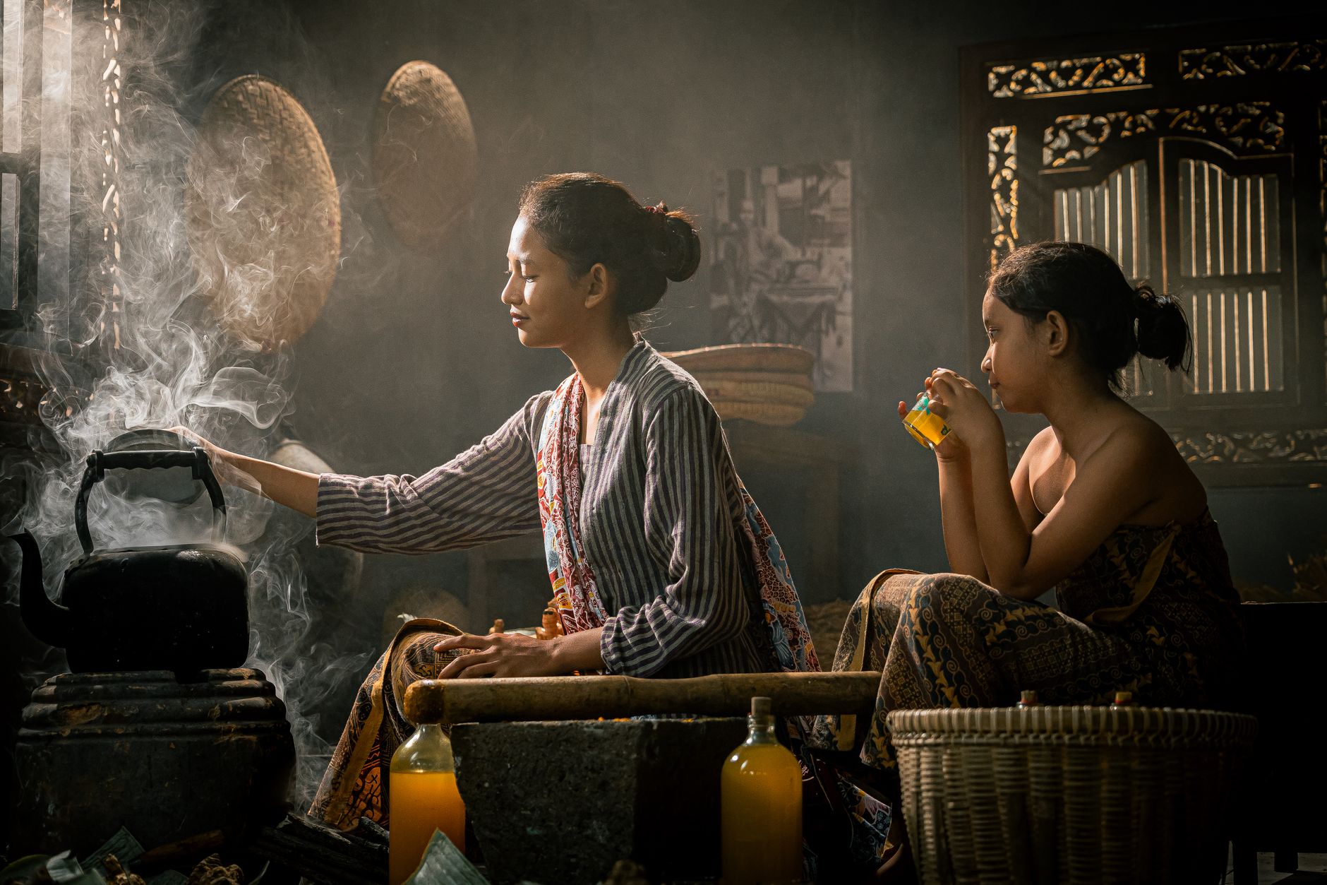 A mother and child in a traditional kitchen setting with warm lighting and steam.