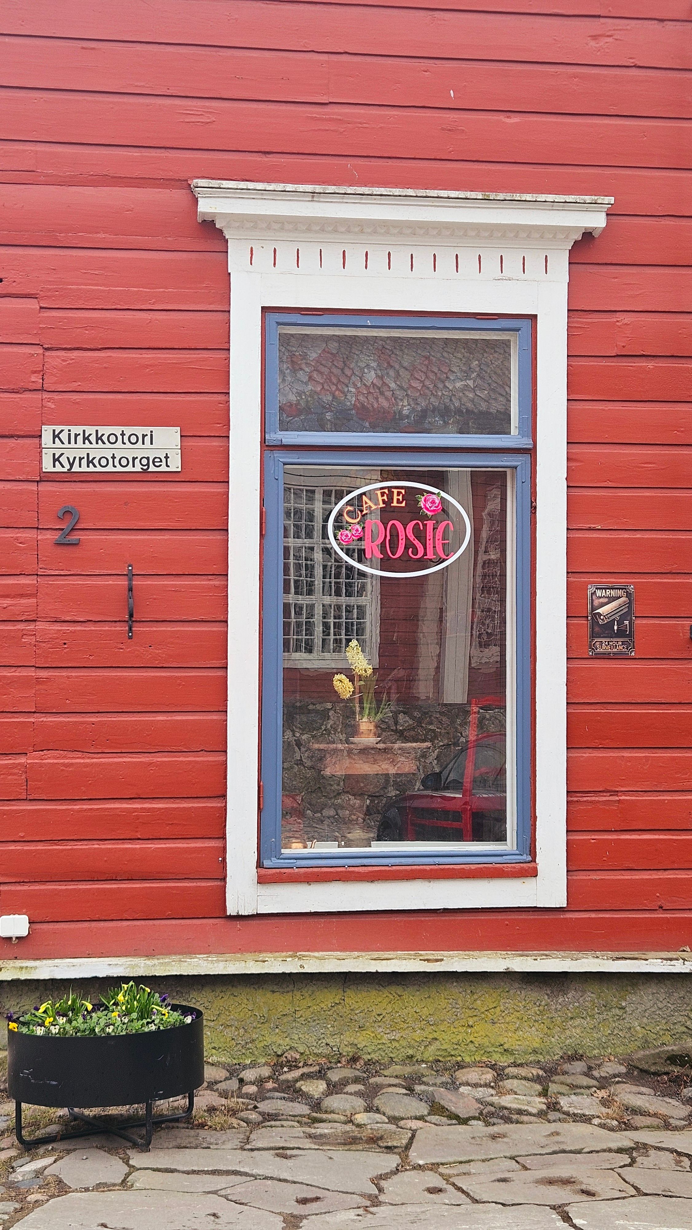 Charming Café Window in Finnish Town Square · Free Stock Photo