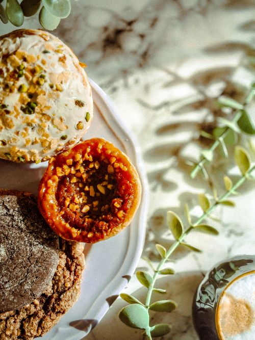 Free Delicious gourmet cookies and pastries on a plate with natural decor, perfect for food lovers. Stock Photo