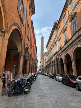 Charming Bologna street scene featuring the iconic Asinelli Tower and historic architecture.