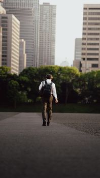 A person walking through the futuristic skyline of Tokyo, Japan, during the day.