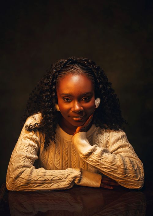 Free A cozy and inviting portrait of a woman in a warm white sweater, exuding confidence and charm. Stock Photo