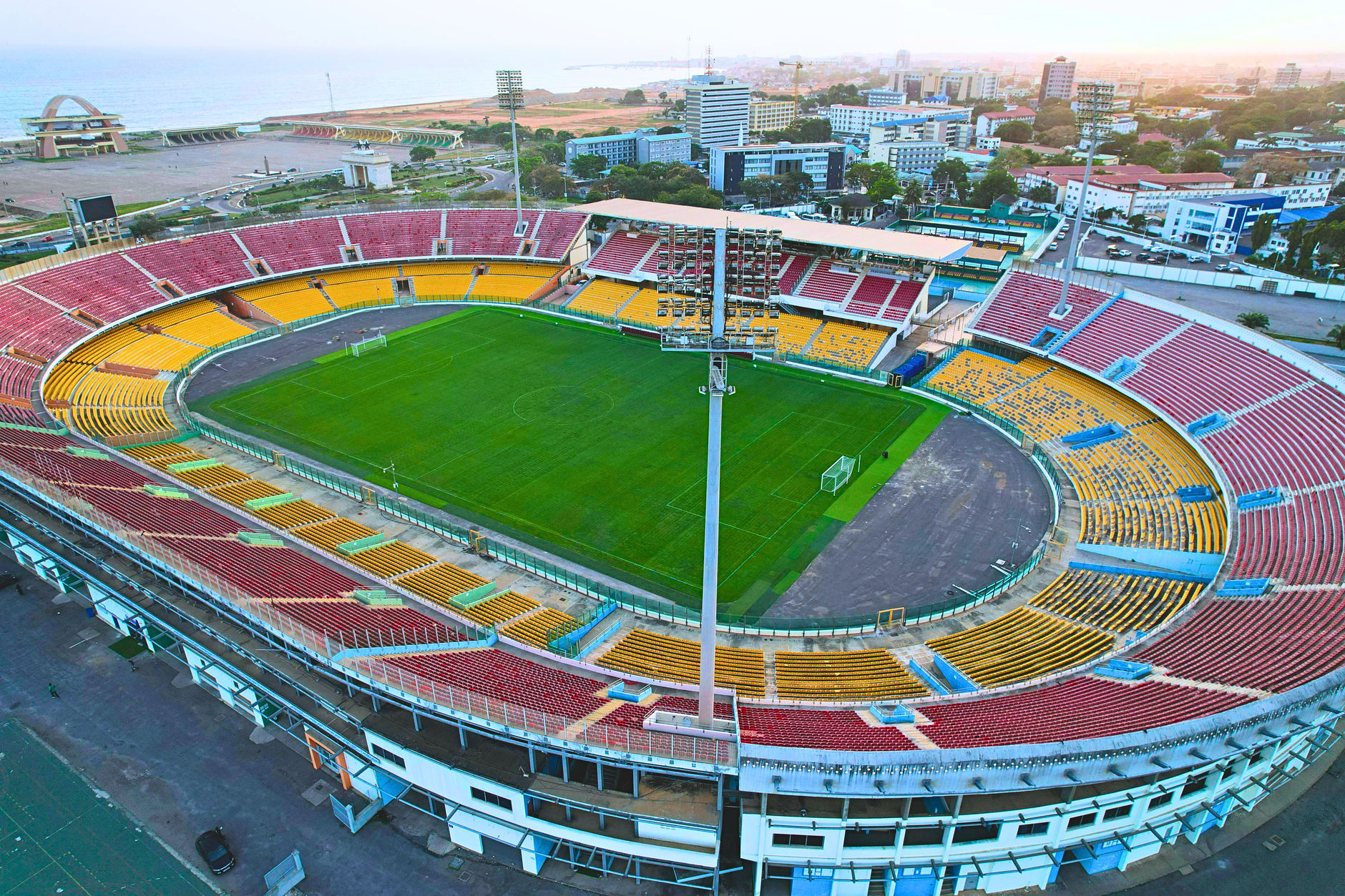 Aerial view of the Accra Sports Stadium, Ghana, at dawn with an empty field.