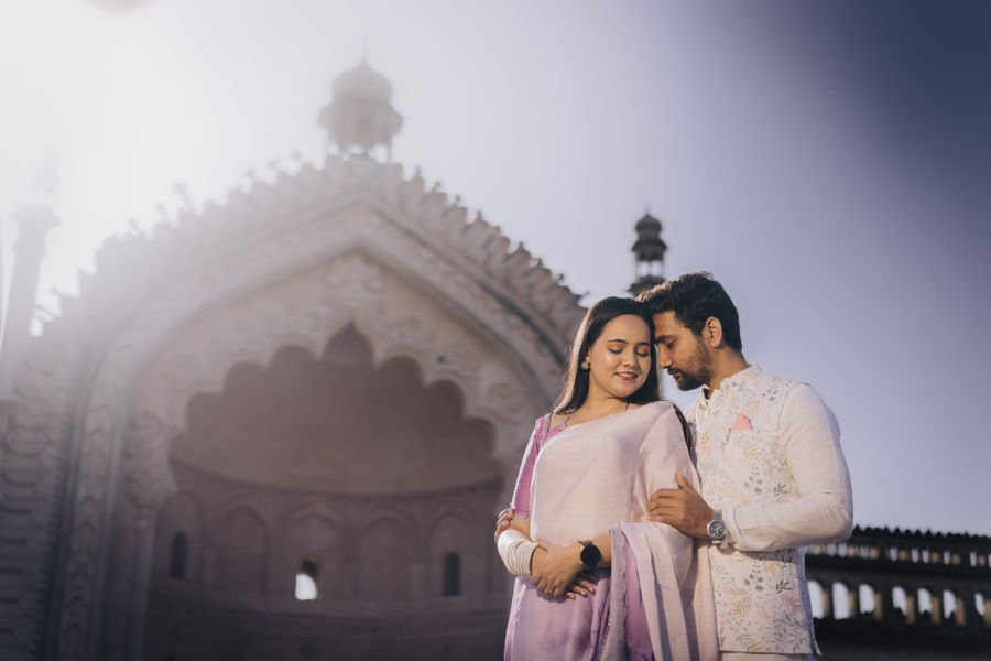 Indian couple embracing at a historic monument