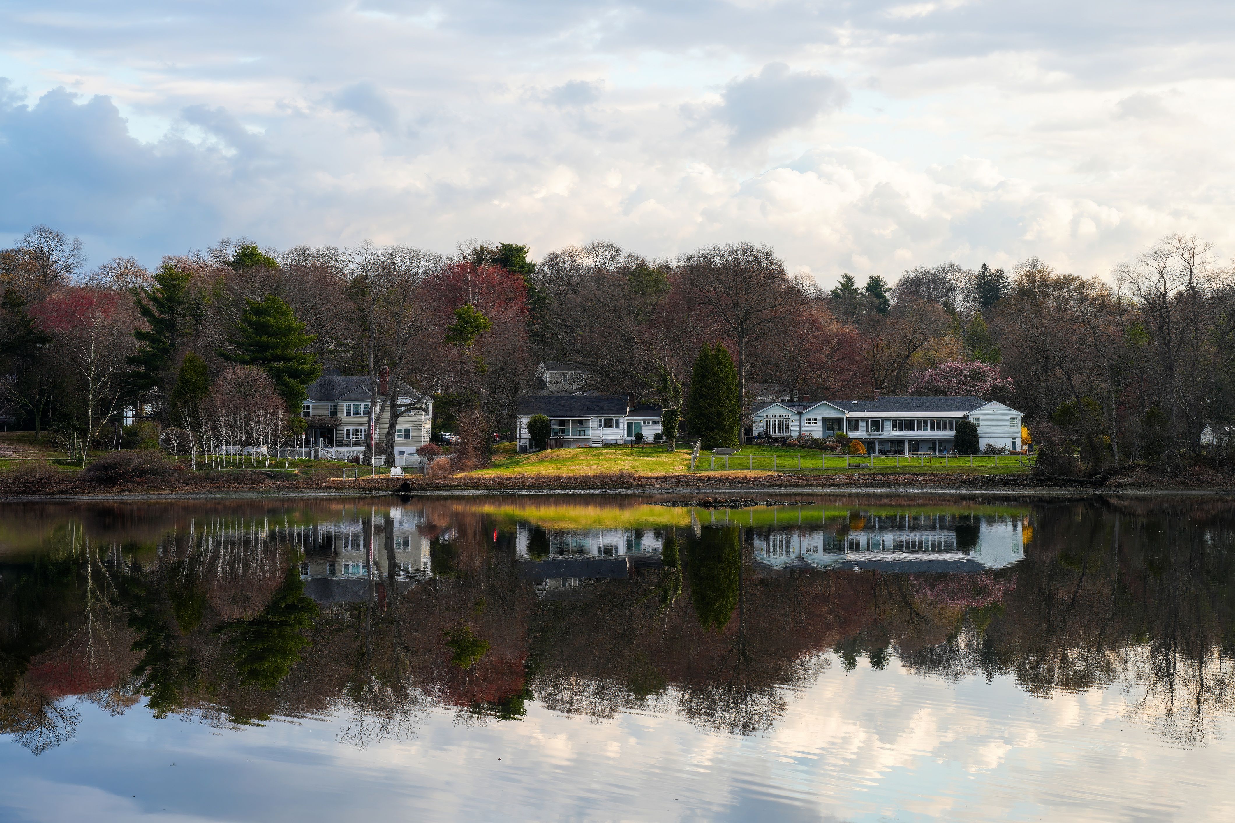 A row of year-round single-family homes on a tree-lined street in Wareham Center MA
