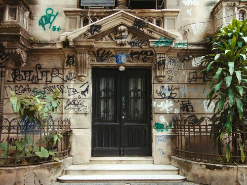 Free Old building facade with graffiti in Rio de Janeiro, Brasil, showcasing urban street art. Stock Photo