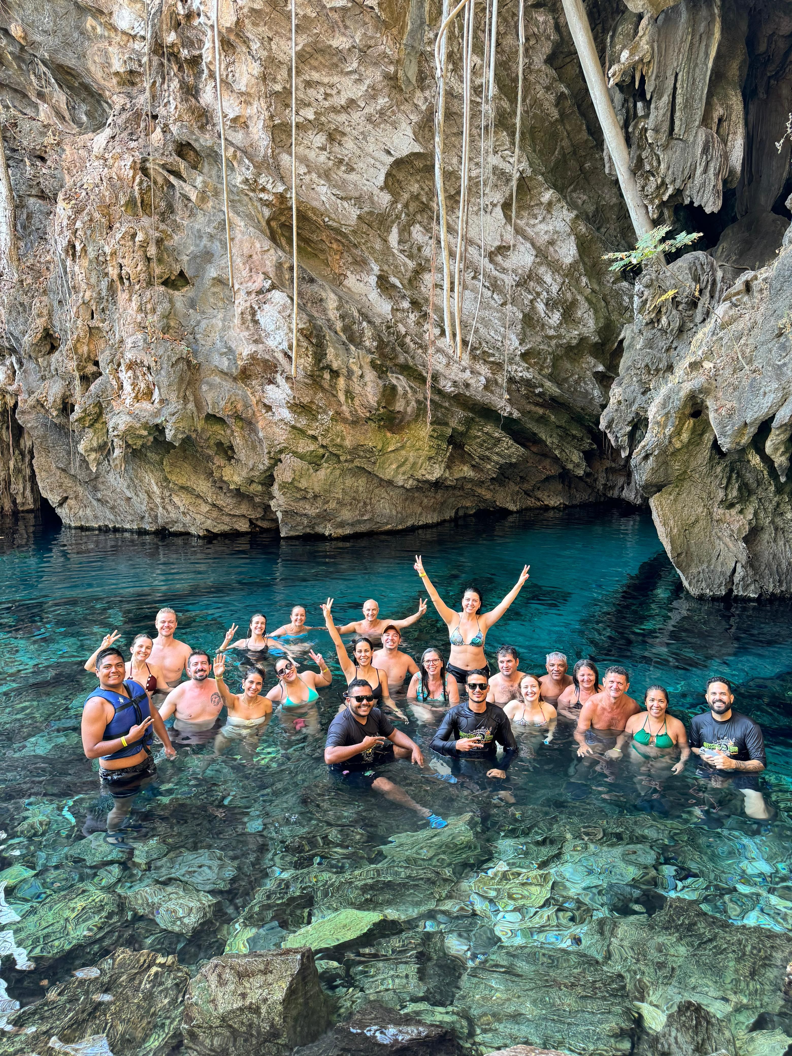 Group Enjoying a Refreshing Cave Swim Adventure · Free Stock Photo