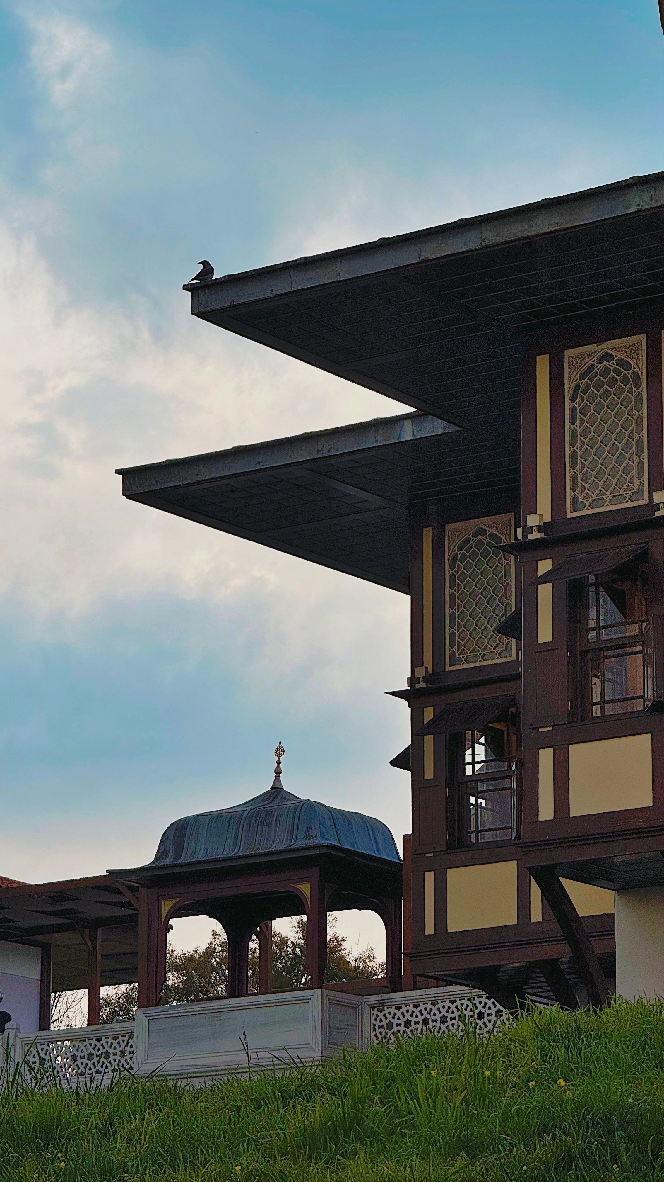 Beautiful traditional architecture with prominent roof design and scenic sky.