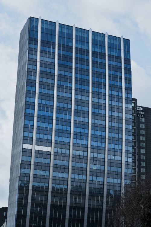 Free Tall modern office building in Copenhagen, showcasing urban architecture with reflective glass facade. Stock Photo