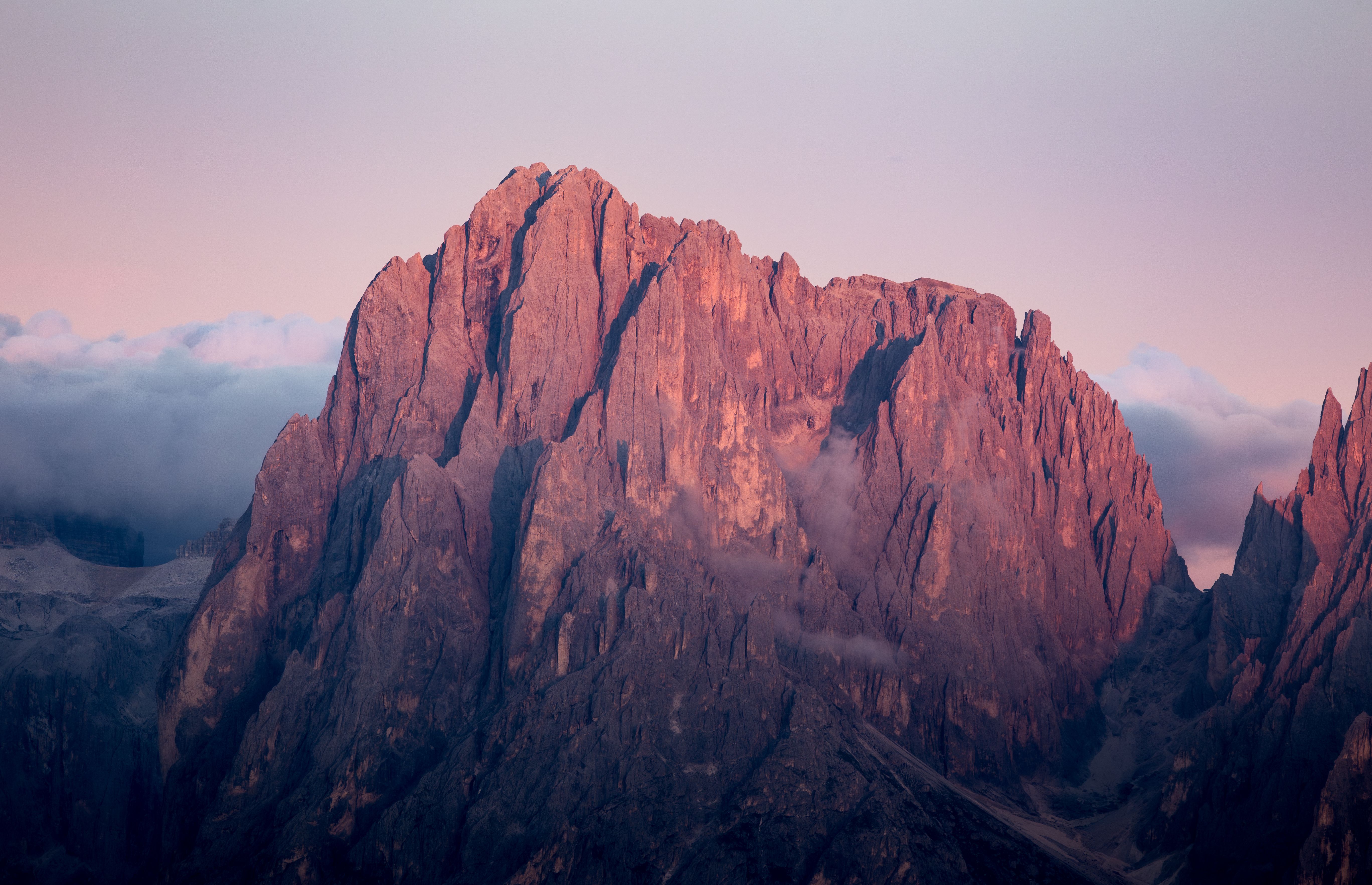 Captivating view of the Dolomites mountains bathed in sunset hues, showcasing nature's beauty in summer.