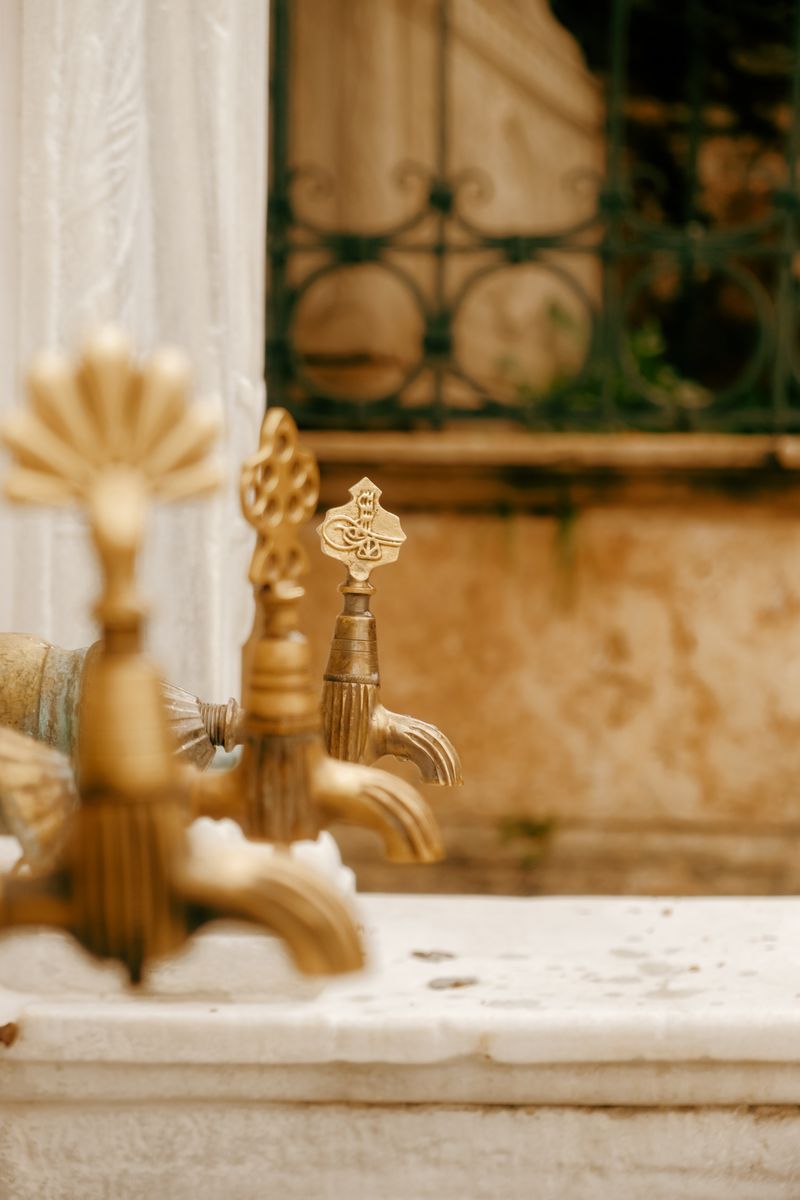Intricate brass fittings on historical fountain