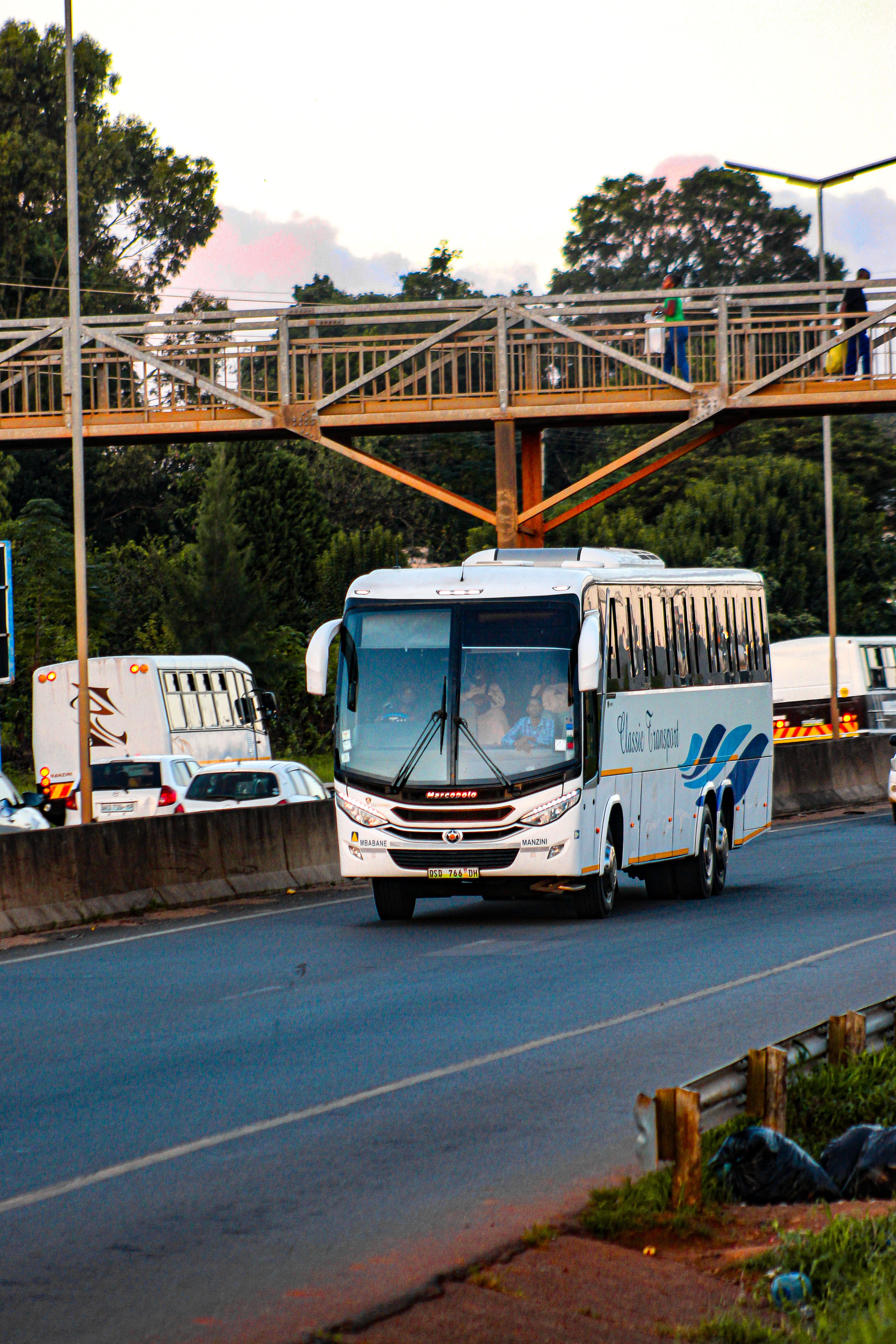 Busy Highway with White Passenger Bus in Eswatini · Free Stock Photo
