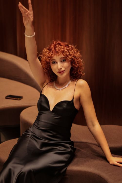 Elegant Woman in Black Satin Dress Posing Indoors · Free Stock Photo