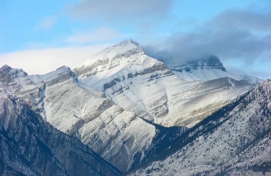 Breathtaking winter landscape of snowy mountain peaks under a blue sky.