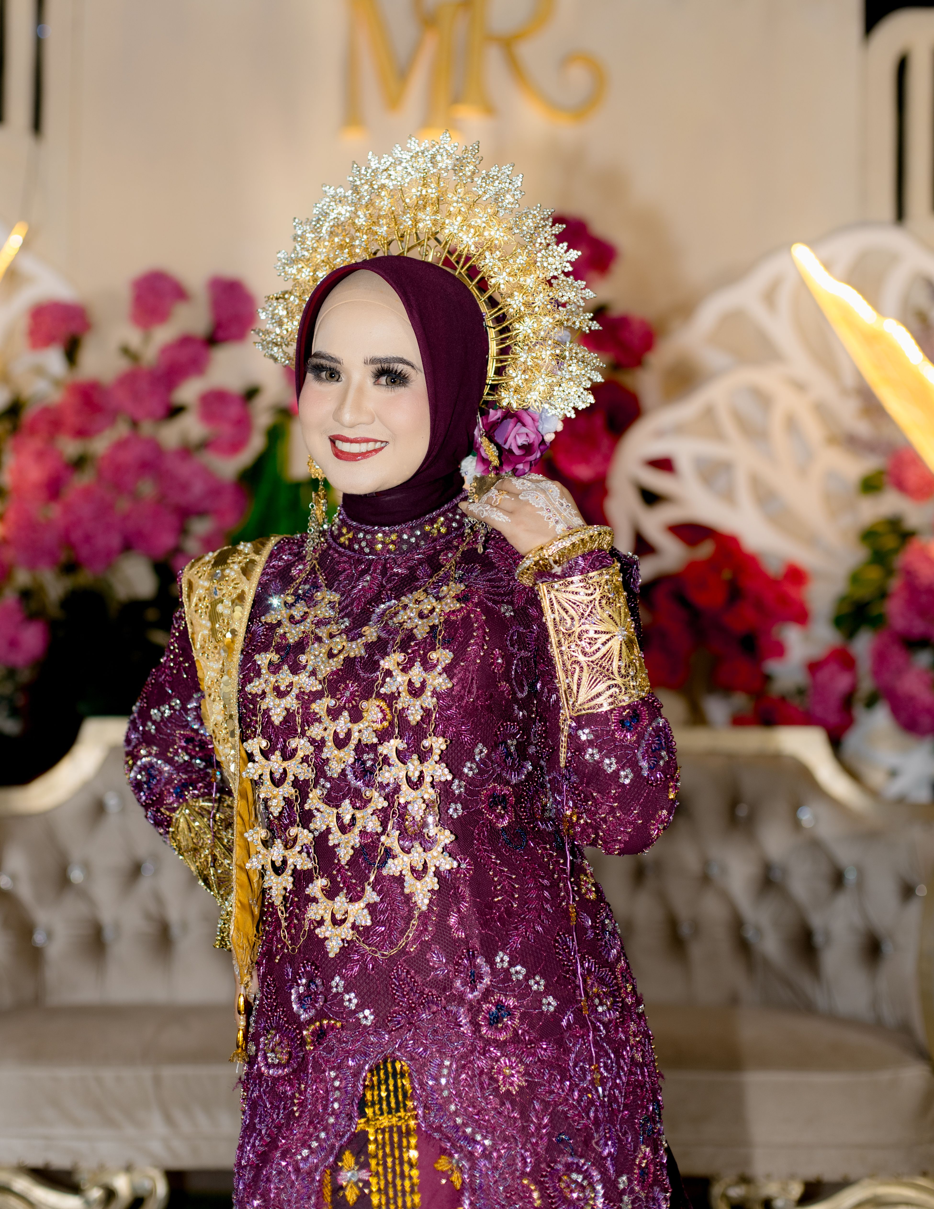 Stunning bridal portrait featuring elegant traditional attire and vibrant floral background.
