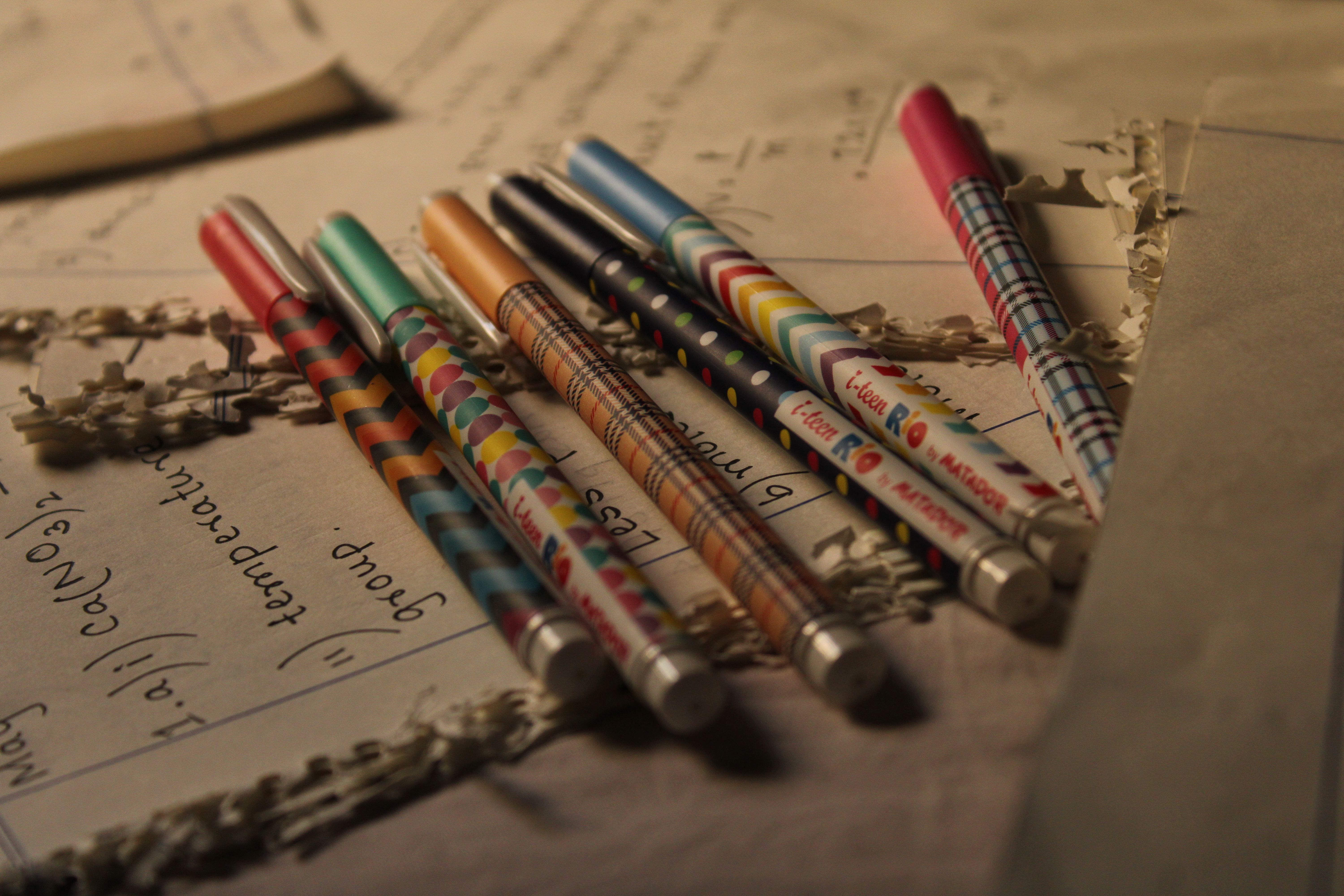 Colorful Pencils on Handwritten Notes · Free Stock Photo