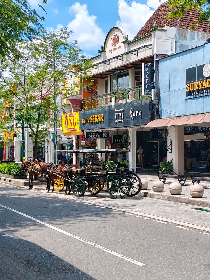 Horse-drawn carriage parked along Malioboro street in Yogyakarta