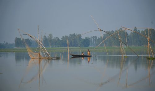 Free A serene view of fishermen on a boat in Rangpur, Bangladesh, capturing daily life. Stock Photo