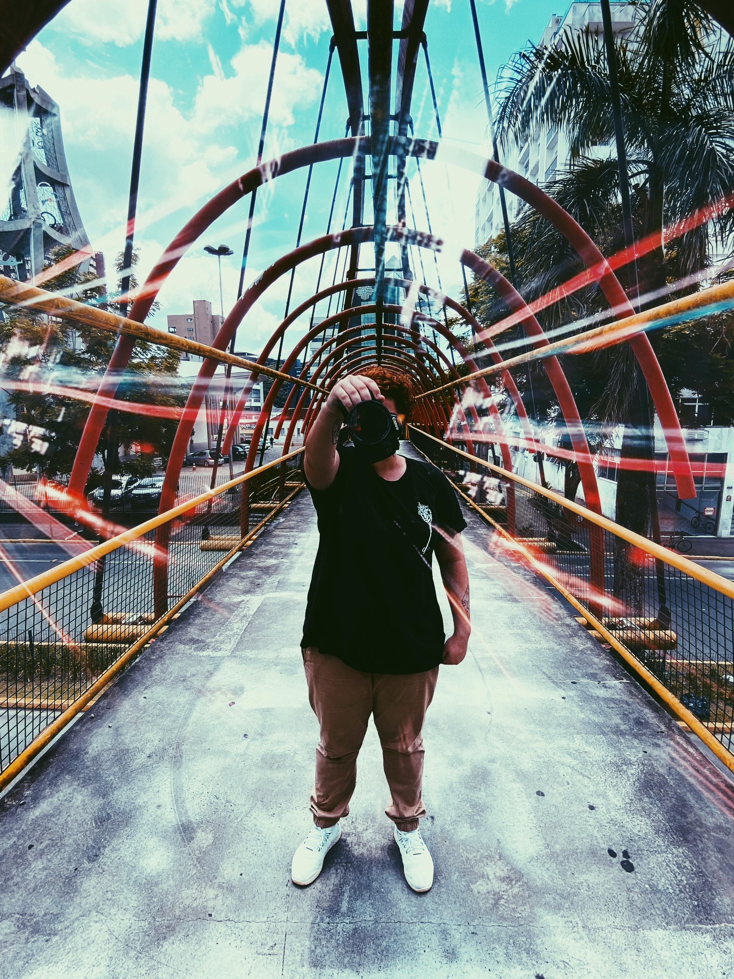 一个人在充满活力、色彩缤纷的城市桥梁上自拍，展现了现代旅行与休闲的主题