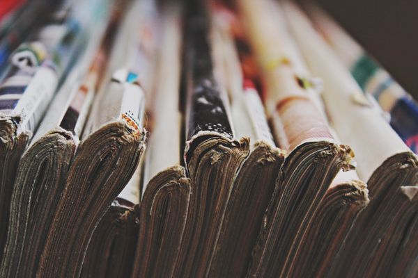 A stack of well-thumbed magazines — photo by Madison Inouye on Pexels