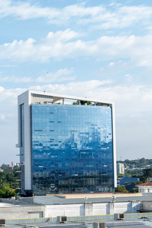Free A contemporary glass office building reflecting the sky in Valle del Cauca, Colombia. Stock Photo