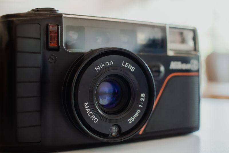 Close-up of a classic vintage 35mm film camera with macro lens focus.