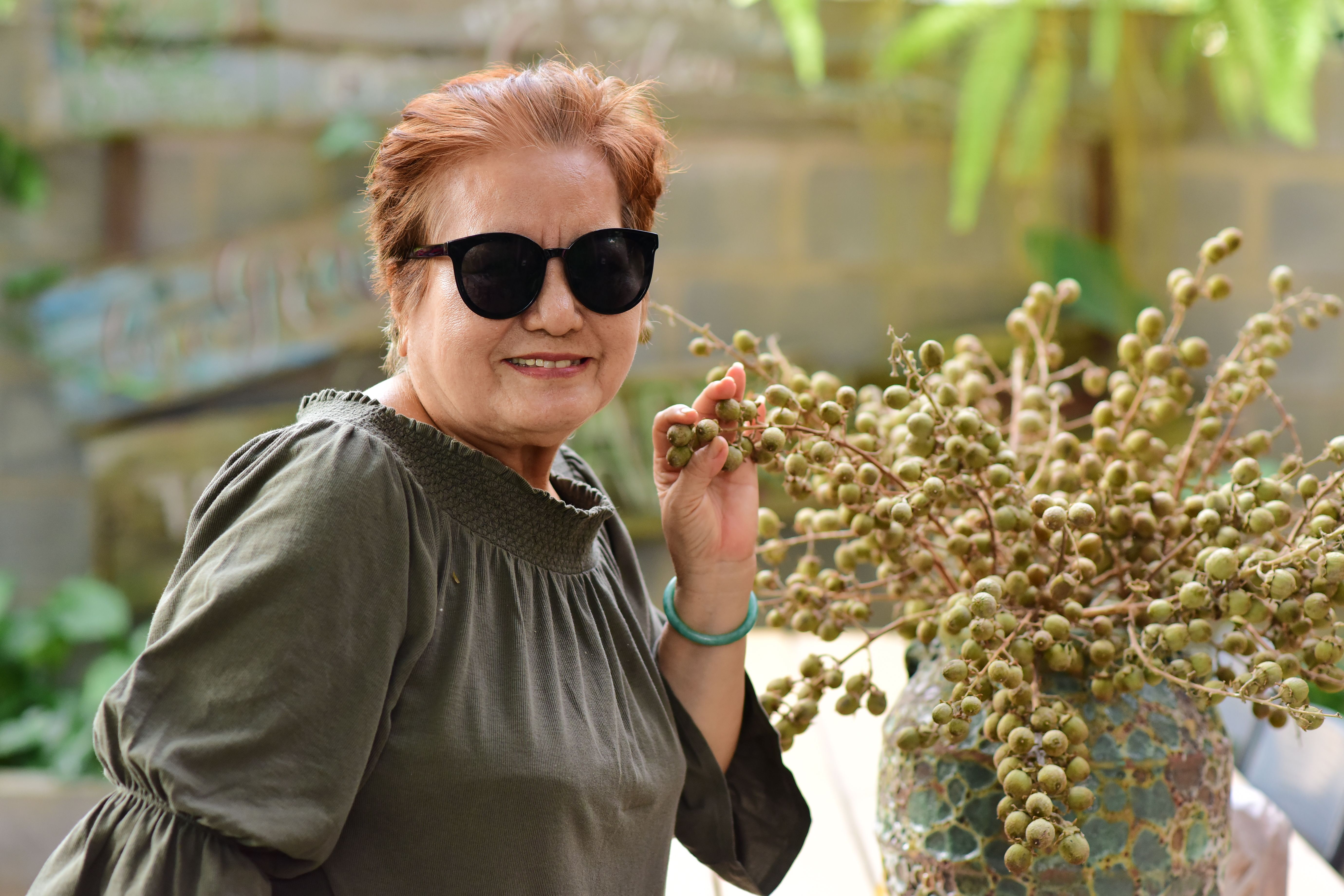 Post-menopausal woman in her 60s smiling outdoors during a morning walk