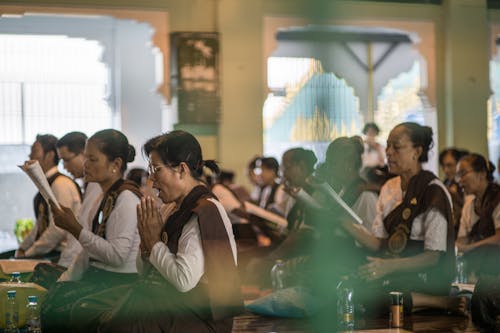 Man and Women in White Long Sleeve Shirt Sitting Beside Each Other