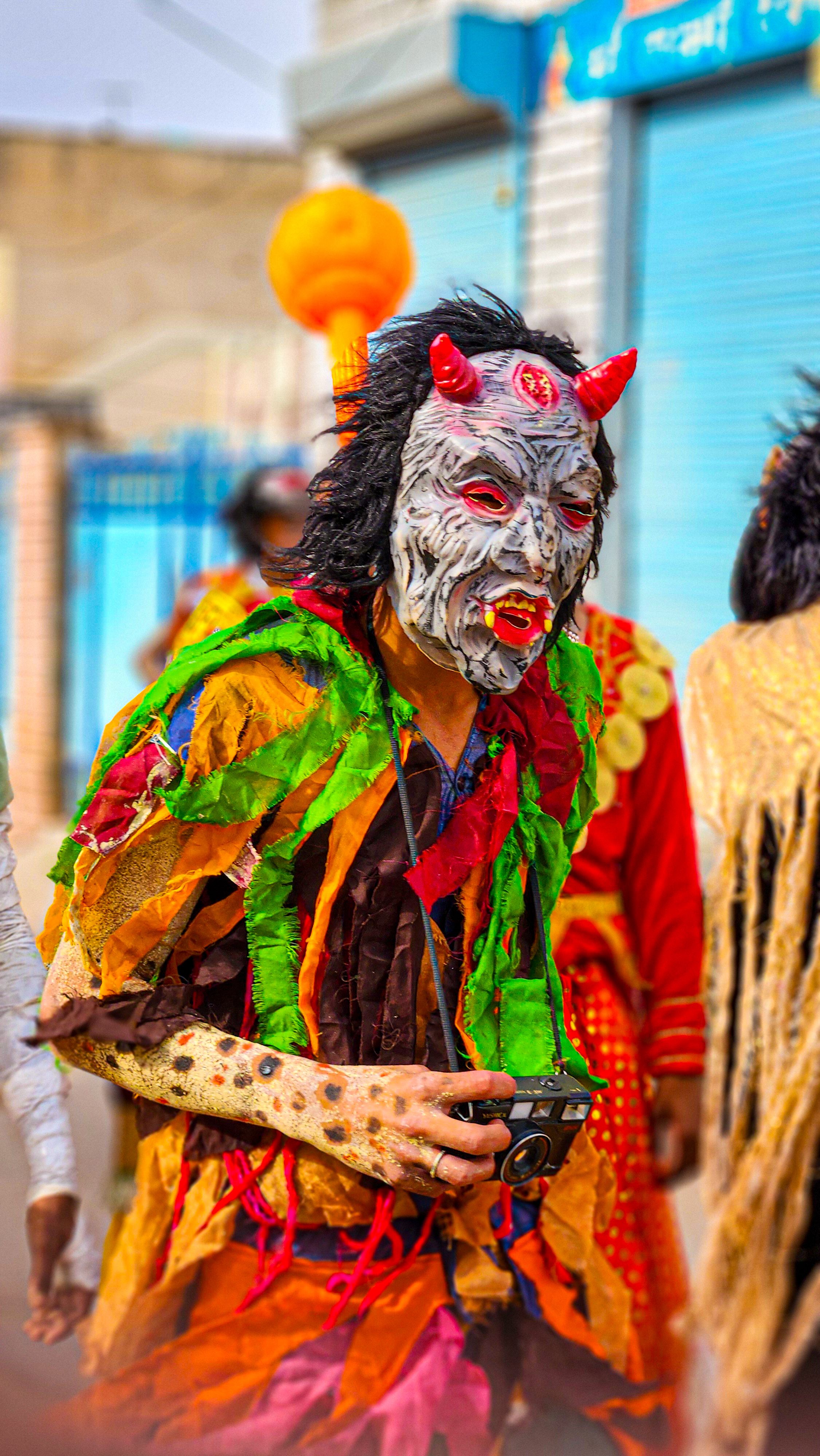 A vibrant festival costume with unique mask in Didwana, Rajasthan.