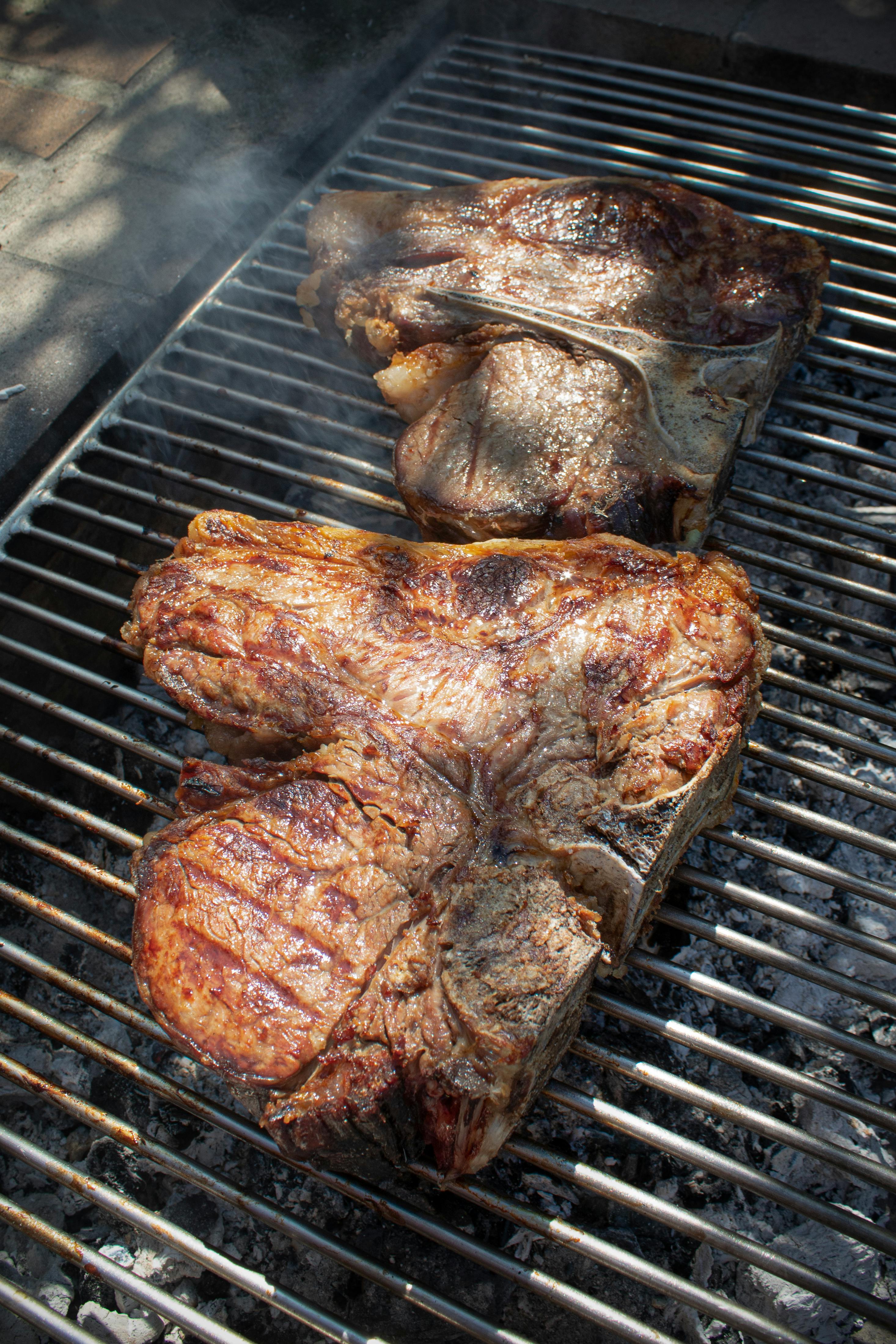 Grilled pork chop resting with thermometer showing internal temperature monitoring