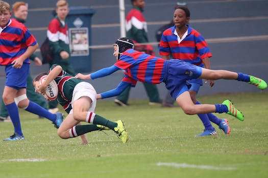 Young athletes engaged in a dynamic rugby match, showcasing teamwork and sport.